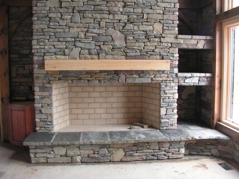 Stone fireplace with a wooden mantel
