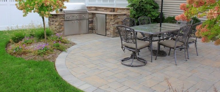 Outdoor patio with kitchen and dining area