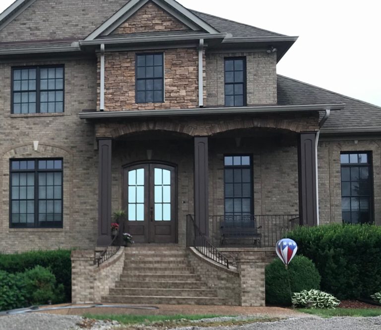 Home with a stone facade and brick steps