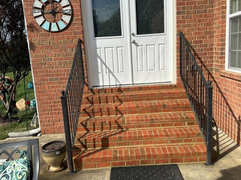Red brick entry steps with railings