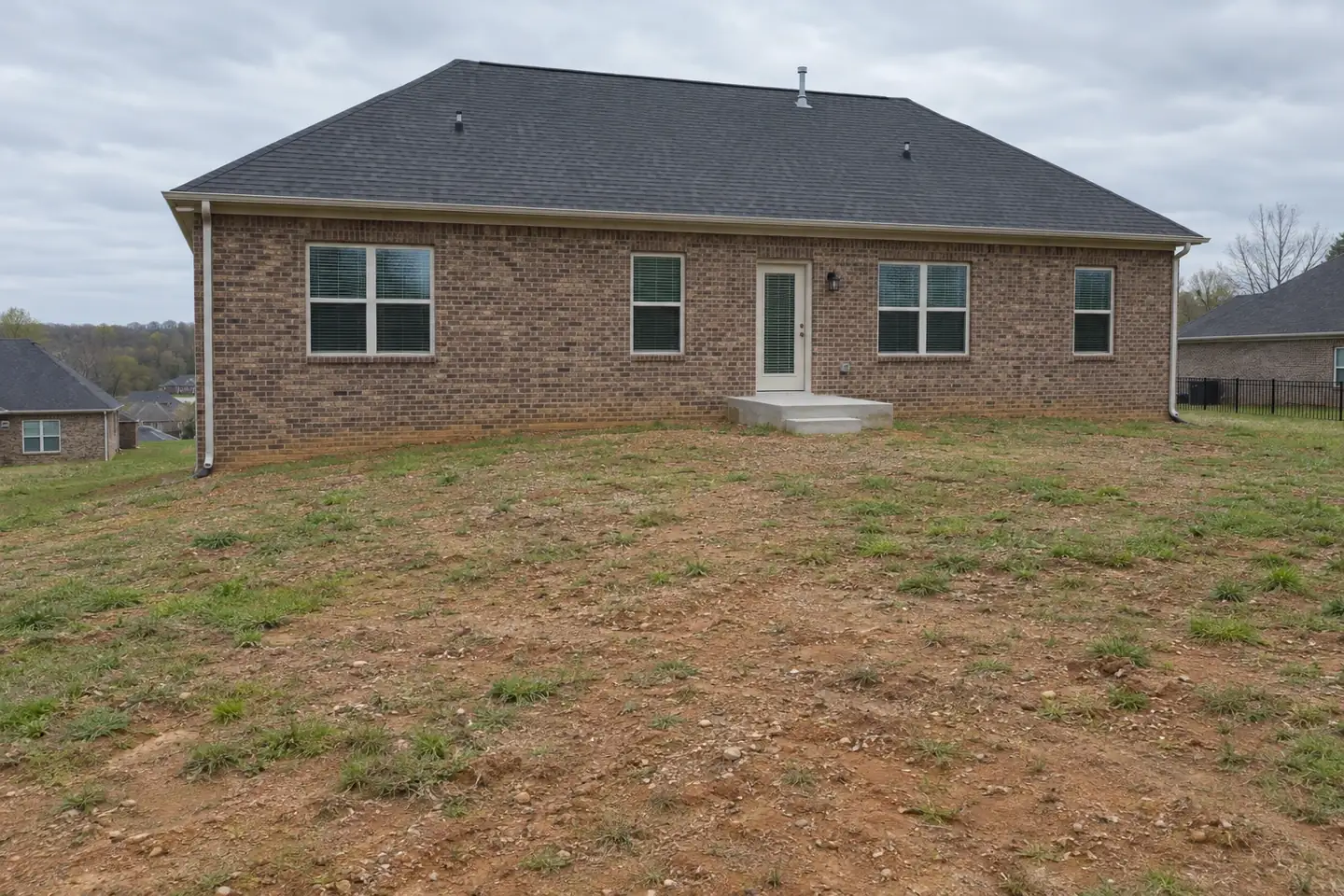 Backyard before and after a patio, fire pit and stone wall - before